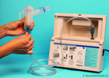 The tubing from the compressor is attached to the bottom of the nebulizer
