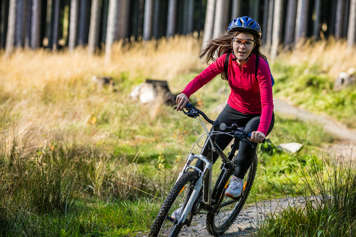 Girl riding bike on a trail
