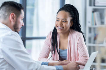 Teen sitting across from a health-care provider