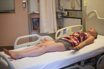 girl laying in hospital bed with eyes closed in relaxation pose