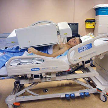 Teen boy in x-ray machine for renal scan