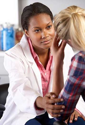 Healthcare professional comforting teen patient