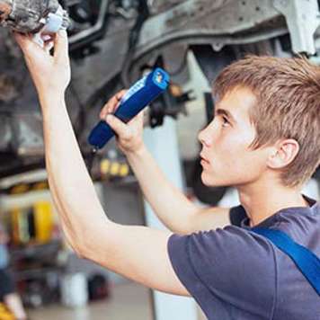 Older teen working as mechanic