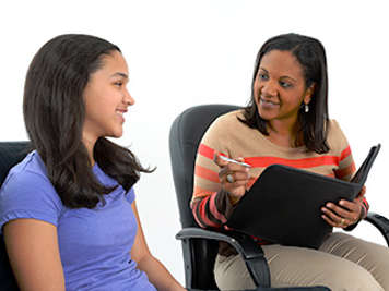 Counsellor talking with teen girl