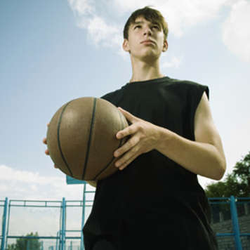 Teen boy holding a basketball