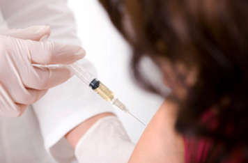 Teen girl receiving vaccine