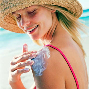 Teen girl applying sunscreen