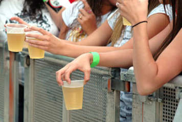 Teens holding plastic cups of beer