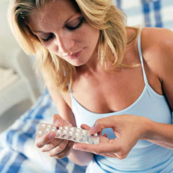 Teen girl holding packet of birth control pills