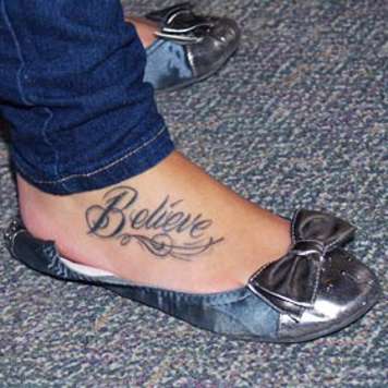 Teen girl with 'believe' tattooed on her foot